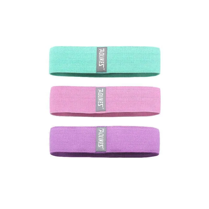 Three fabric booty bands in green, pink and purple